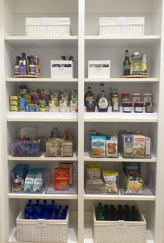 Organized pantry shelves with various food and condiment items neatly arranged.