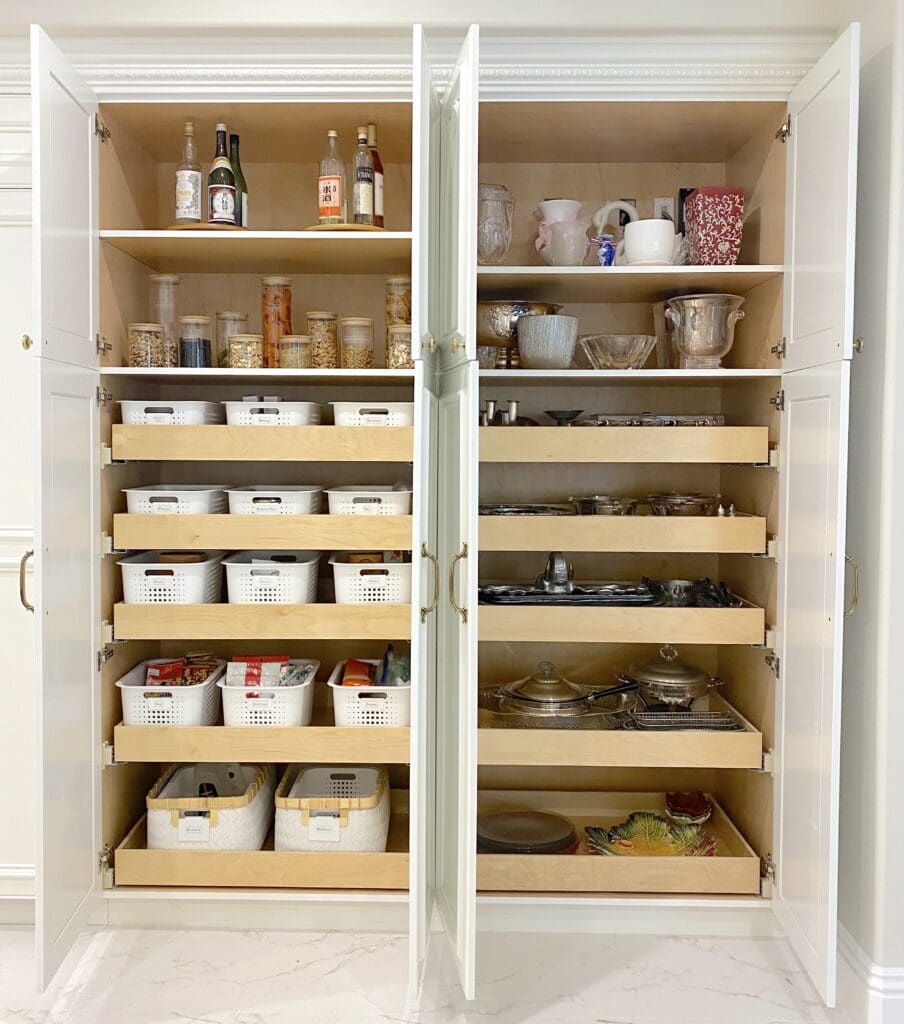 A neatly organized kitchen cabinet with labeled containers and jars.