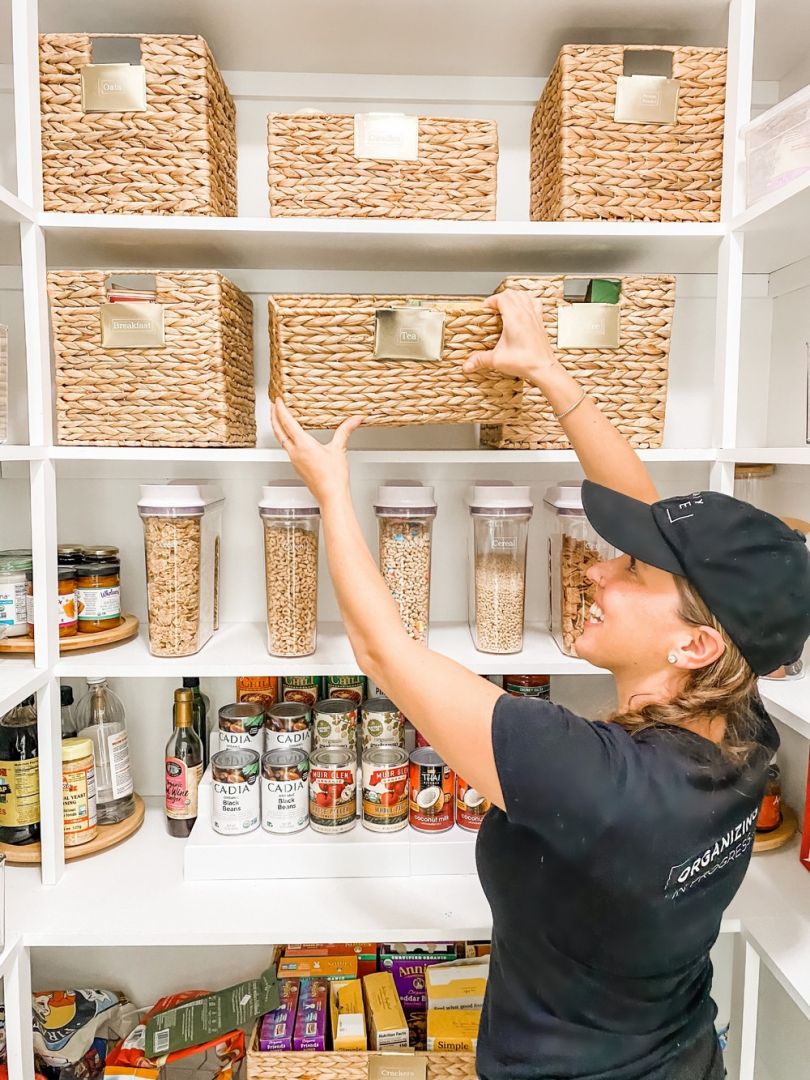 A Woman Organizing a Kitchen With Jute Bags