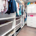 A White Color Closet Space With Coat Racks