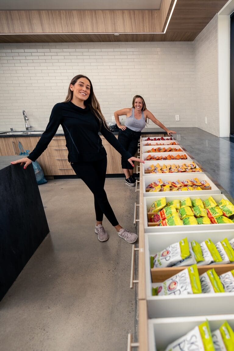 Simply Luxe organizer beside a long counter of sorted snack drawers in a corporate office