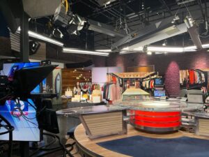 A television studio with a table and chairs
