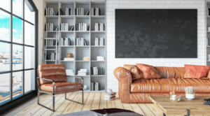 A living room with a leather couch and bookshelves
