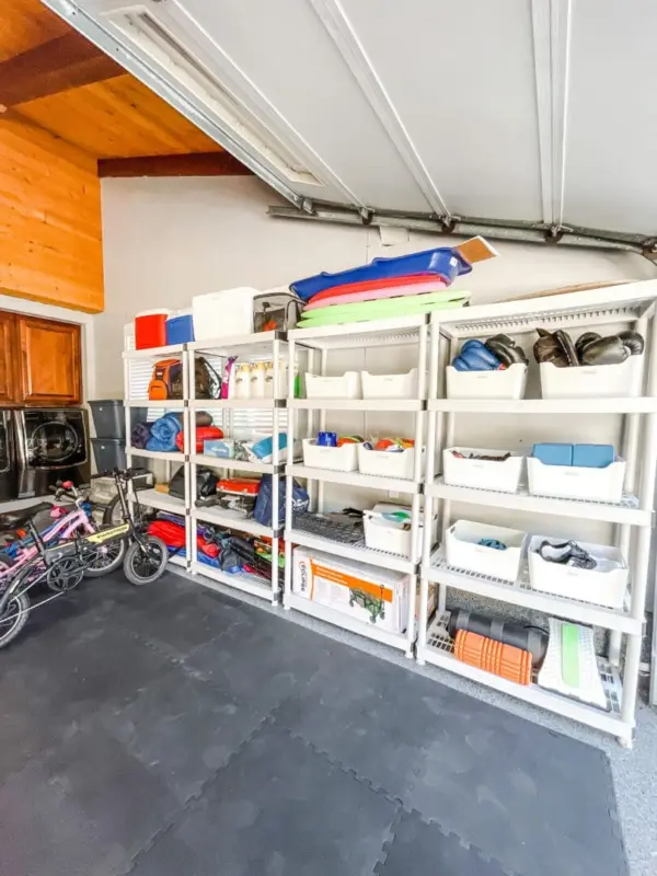Garage with white shelving, labeled containers and bikes, organized by Simply Luxe
