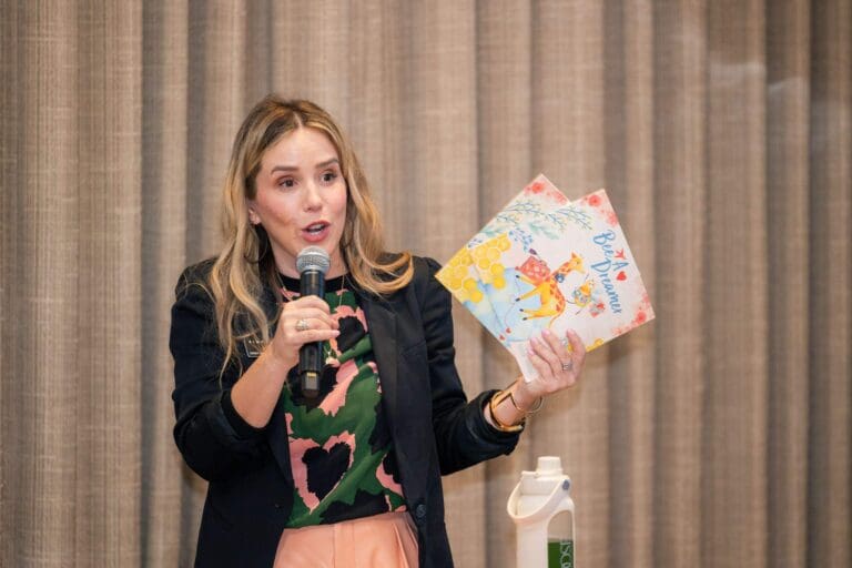 Ryen Toft giving away copies of her children's book, Bee a Dreamer, at the MGM Valentine's Day event