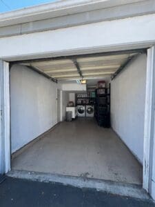 Garage after decluttering, opened up with the washer, dryer and shelves at the back