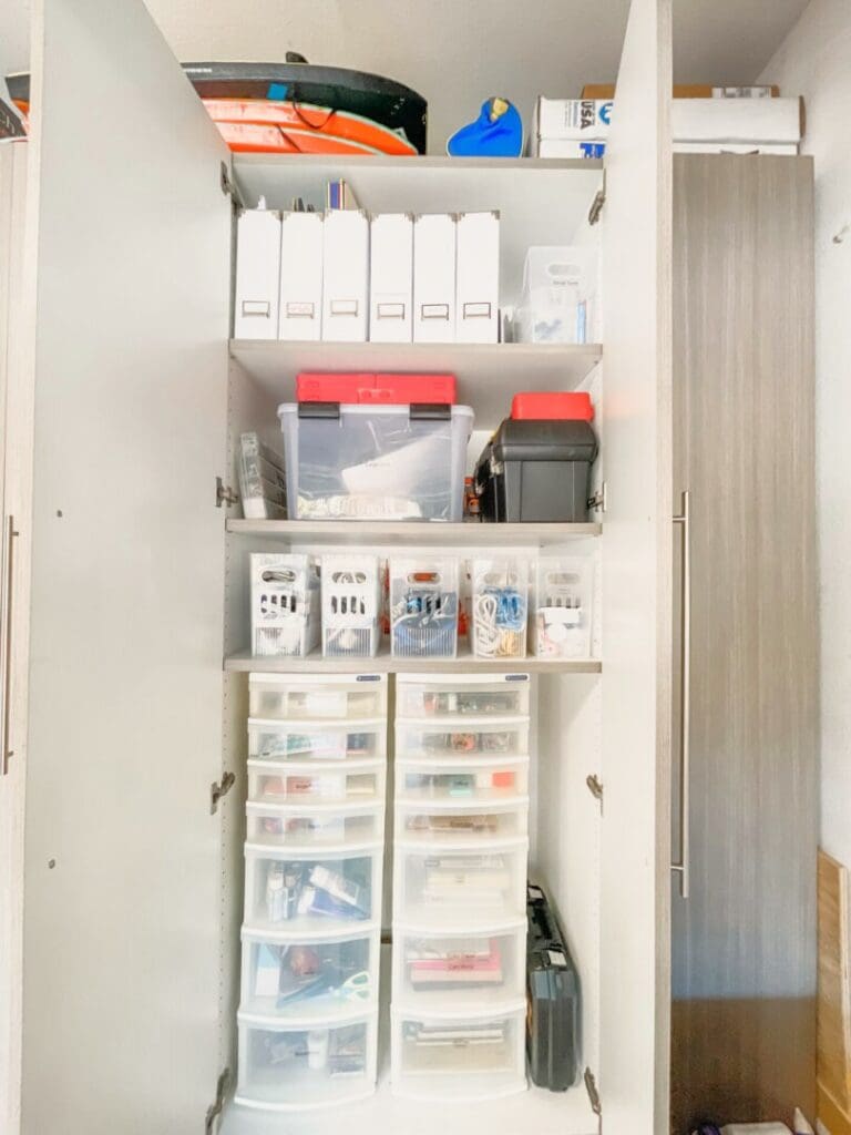Garage cabinet with labeled containers and clear drawers for small items