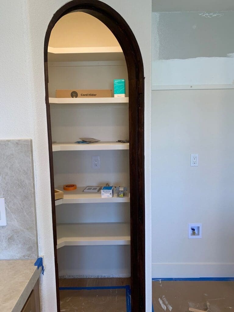 Empty arched pantry cabinet in a newly remodeled Mission Viejo kitchen before organizing
