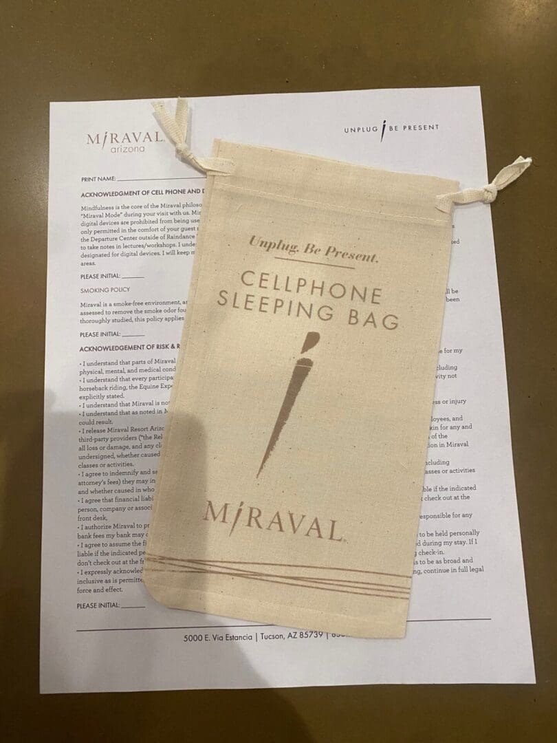 Cellphone sleeping bag packaging with a letter in the background.