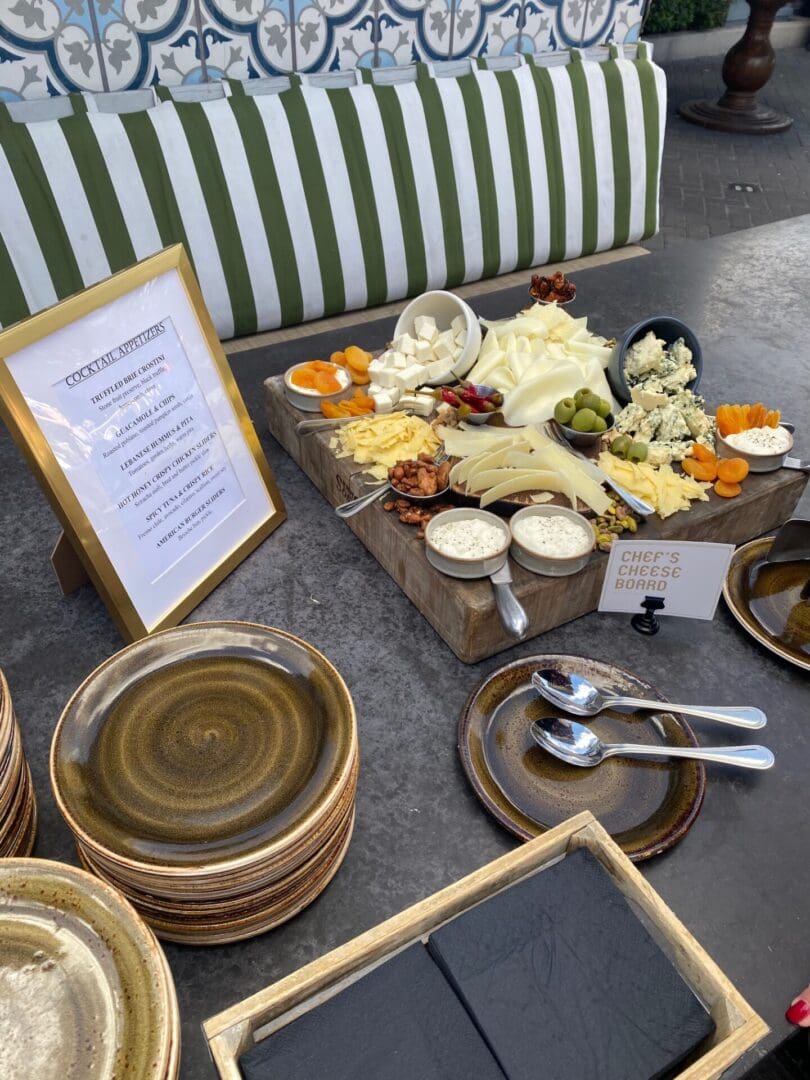 A dessert buffet with ice cream, sauces, and plates.