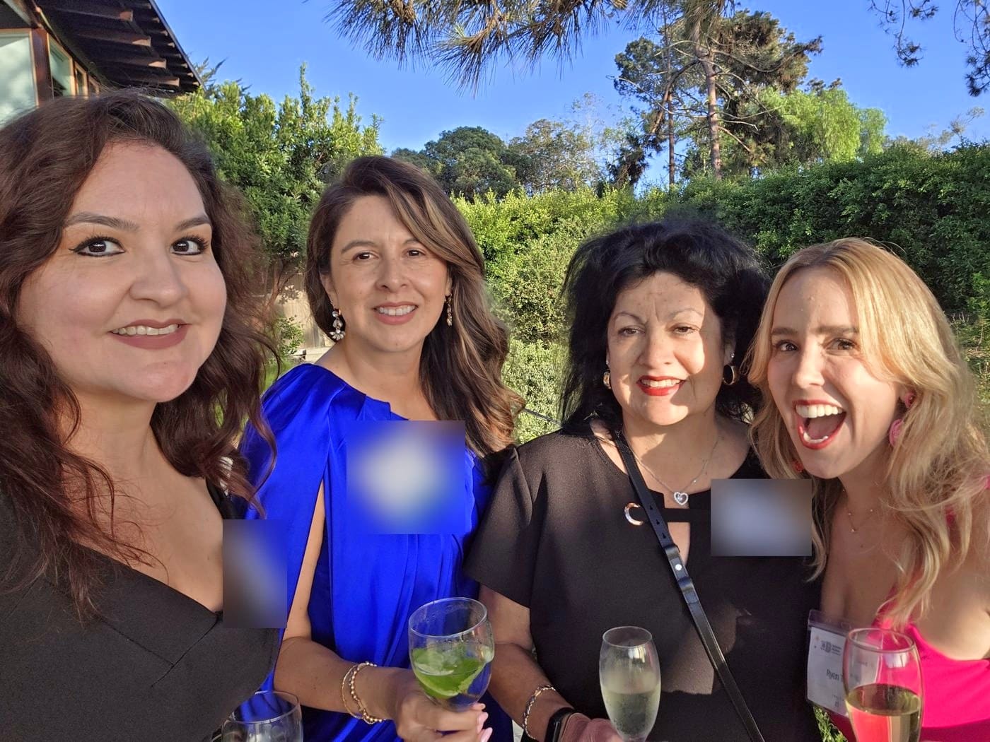 Ryen Toft laughing with three fellow guests at the Big Brothers Big Sisters of San Diego County gala in Point Loma
