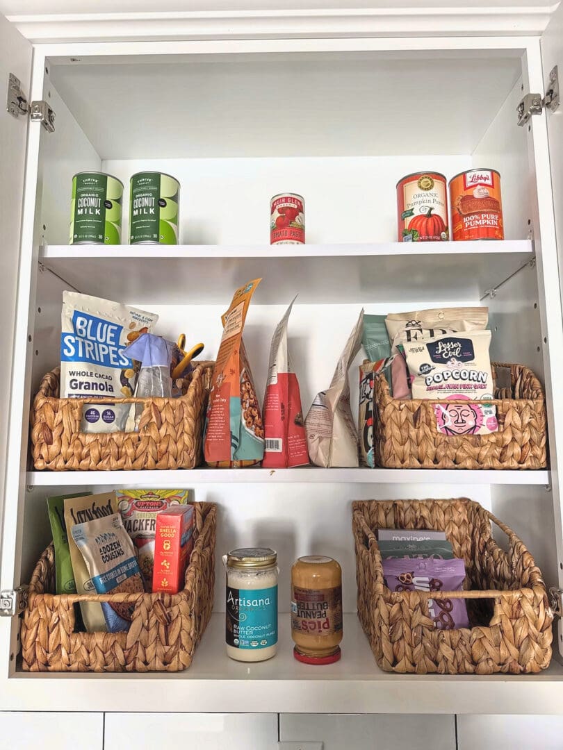 Organized kitchen pantry with woven baskets after Simply Luxe reset