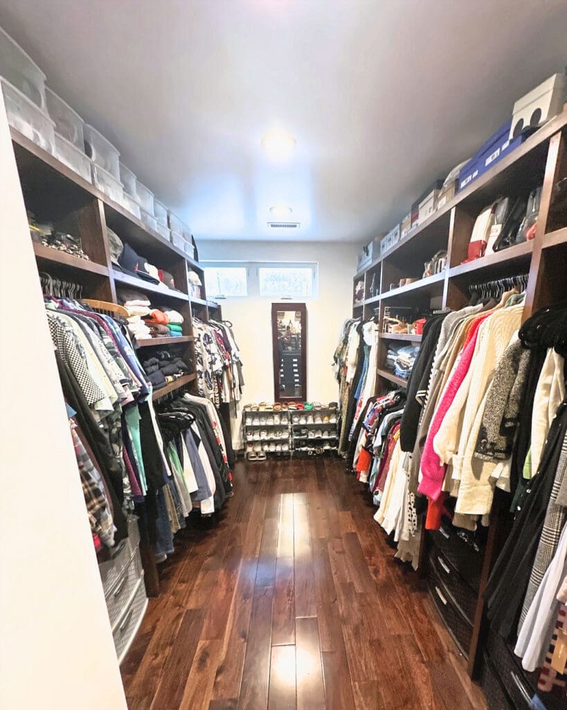 Same walk-in closet after a Simply Luxe declutter session, with a clear floor and shoes on a rack at the far wall, San Diego
