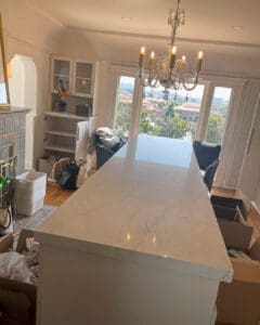 Closet island mid-unpack with bins and bags being edited and put away, San Diego
