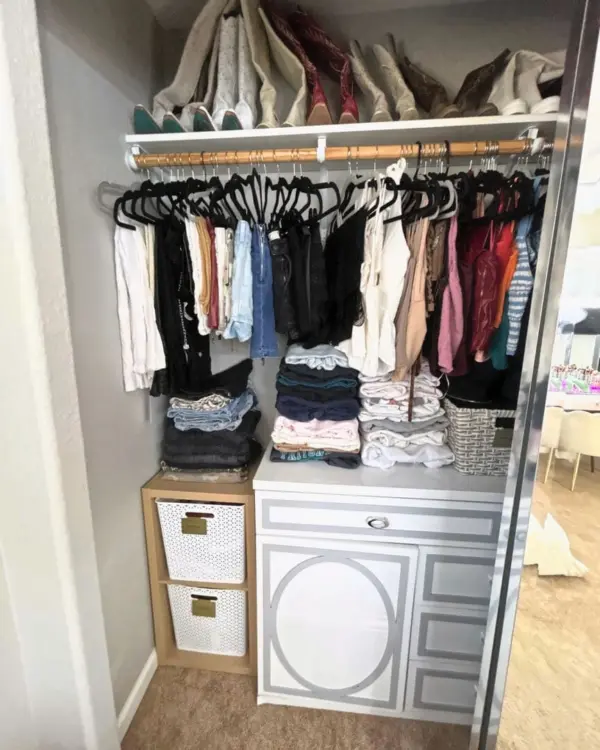 Reach-in bedroom closet after Simply Luxe organizing, with matching hangers, folded stacks and labeled bins, Orange County