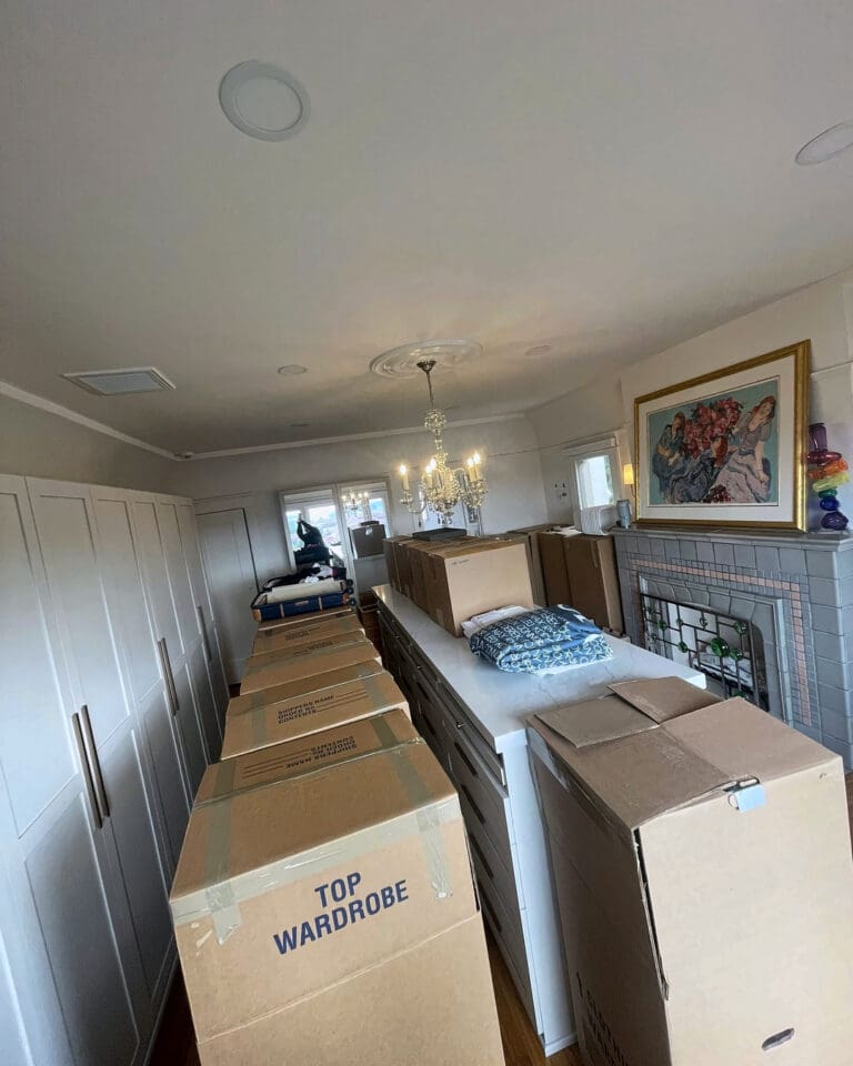 New closet room on moving day, lined with tall wardrobe boxes before unpacking, San Diego