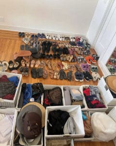 Shoes and handbags sorted into categories on the floor during the closet unpack, San Diego