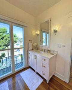 Closet vanity with sconces beside French doors to the balcony view, San Diego