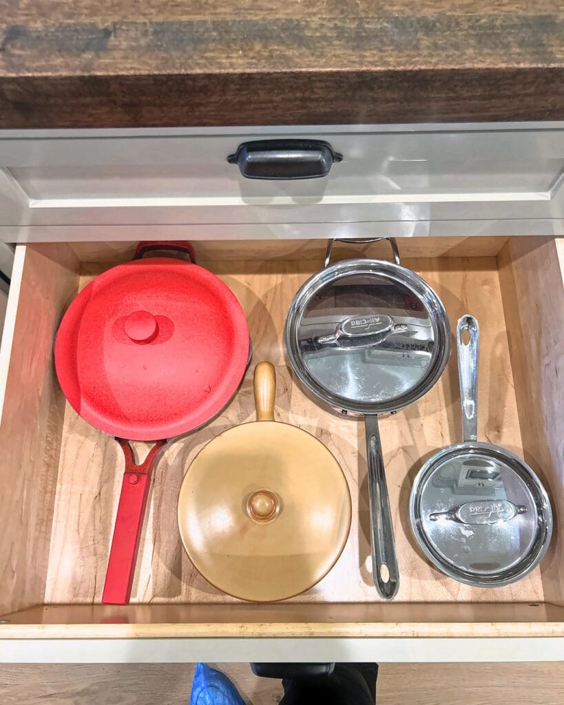 Deep cookware drawer with pans and lids set up after Simply Luxe move-in organizing in Del Mar