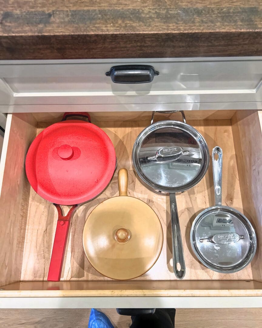 Deep cookware drawer with pans and lids set up after Simply Luxe move-in organizing in Del Mar