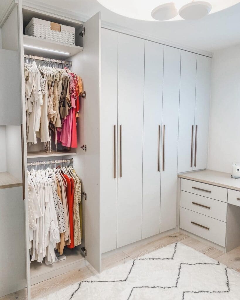 Linen wardrobes and open hanging in a La Jolla dressing room closet organized by Simply Luxe