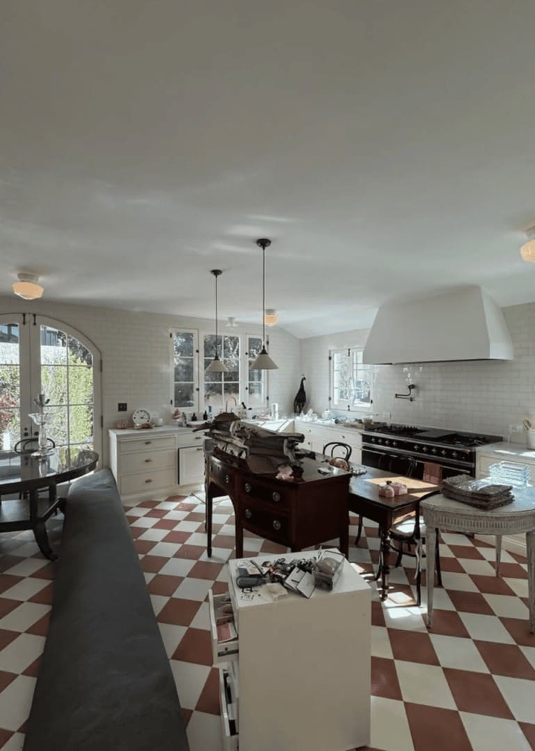 Luxury kitchen with red and white checkered floor and black range during Simply Luxe organization for Eileen Kelly Vogue feature