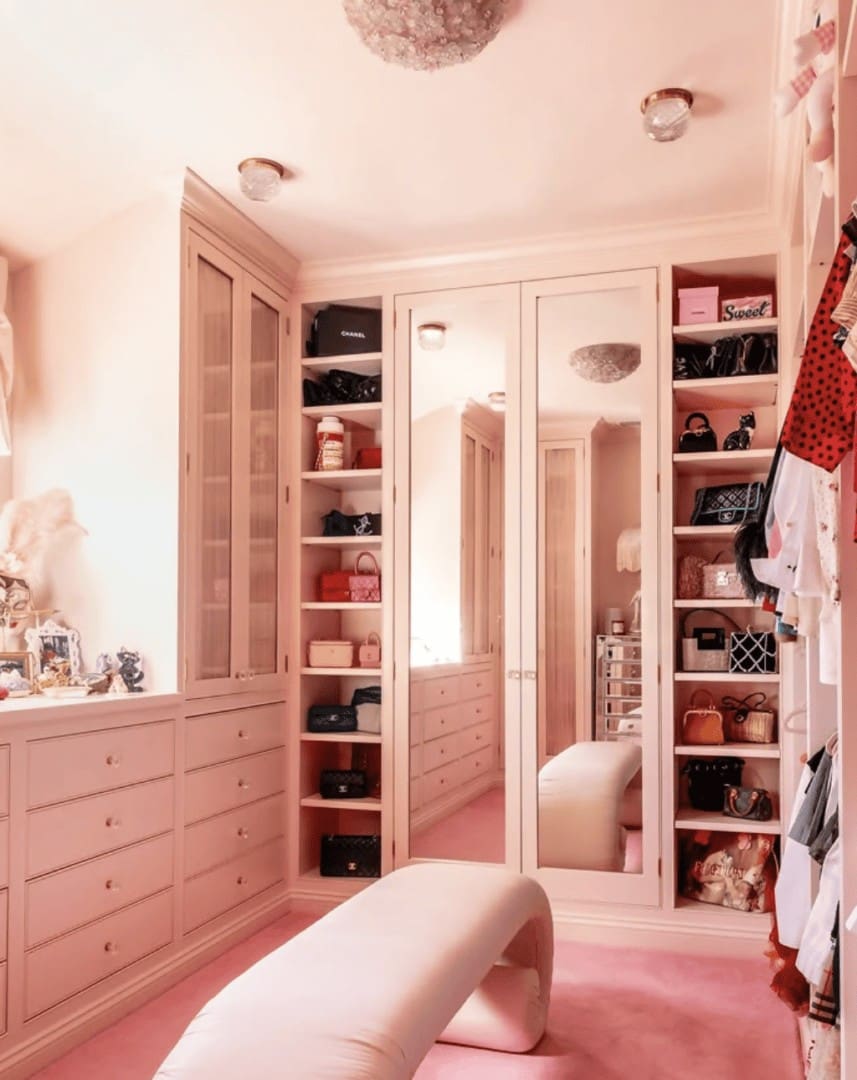 Organized blush pink walk-in closet with designer handbags and custom cabinetry by Simply Luxe for Eileen Kelly