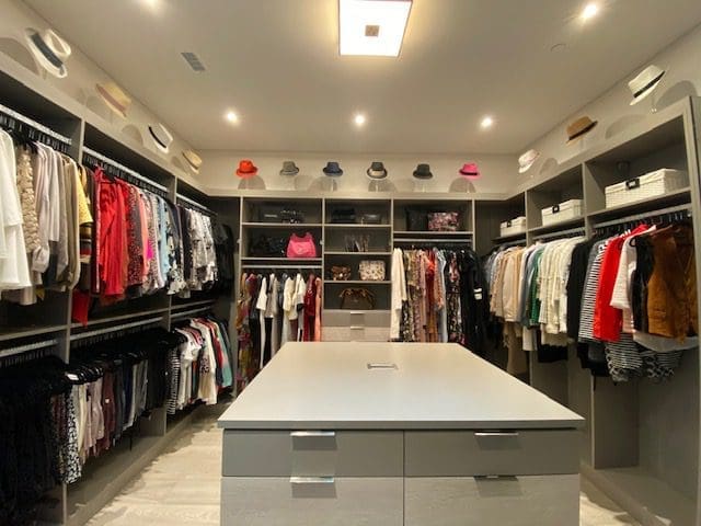 FOX 5 studio walk in closet with lots of clothes shoes and hats
