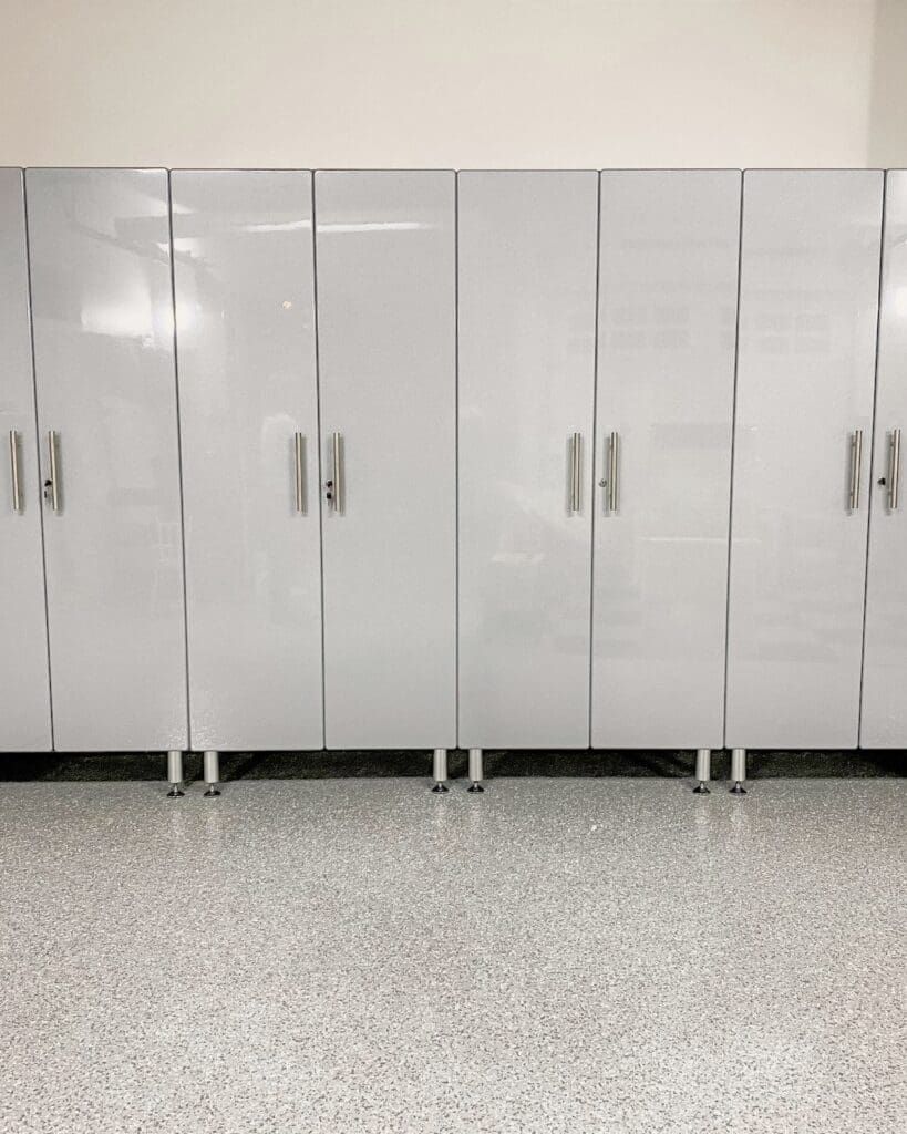 Same Solana Beach garage cabinet wall after, with a row of closed gray cabinets and a clear epoxy floor