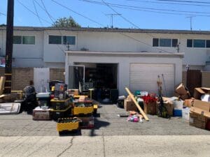 Driveway sale with sorted items laid out during a garage decluttering project