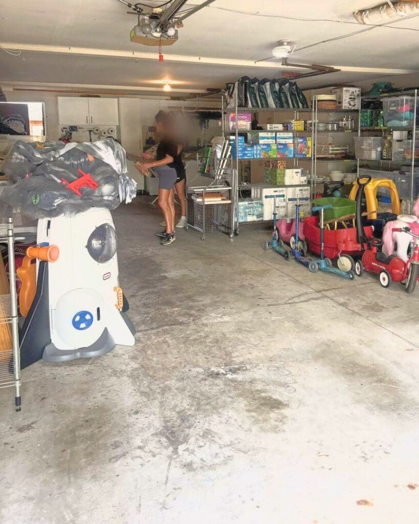 Same two car garage after Simply Luxe organizing, with clear bins on wire shelving, ride-on toys parked in a row and an open floor, Laguna Beach