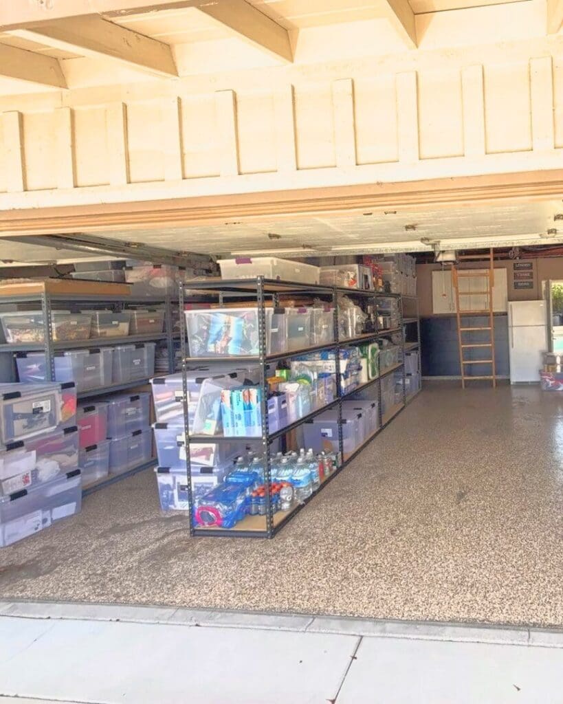 Same two car garage after Simply Luxe organizing, with clear bins sorted on rows of shelving and the floor open to the back wall, Santa Ana