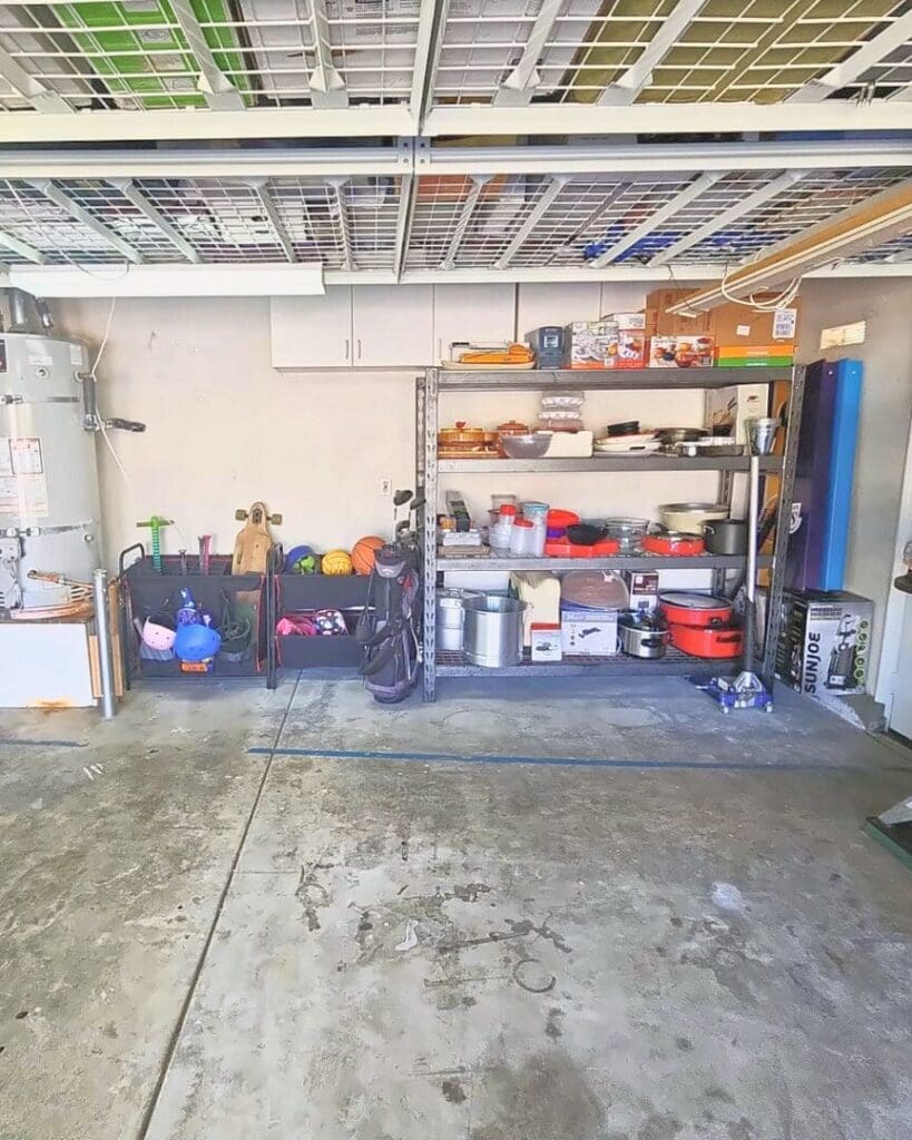 Same garage after Simply Luxe organizing, with kitchen and party supplies sorted on one shelving unit, sports gear in floor bins and an open floor, Chula Vista