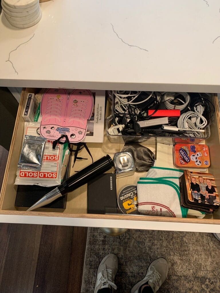 Overstuffed kitchen drawer before Simply Luxe packed the home in Mission Viejo
