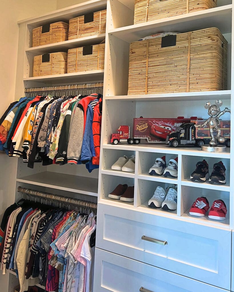 Same kids closet after Simply Luxe organizing, with woven baskets up top, toy trucks on display and shoes in cubbies, San Diego