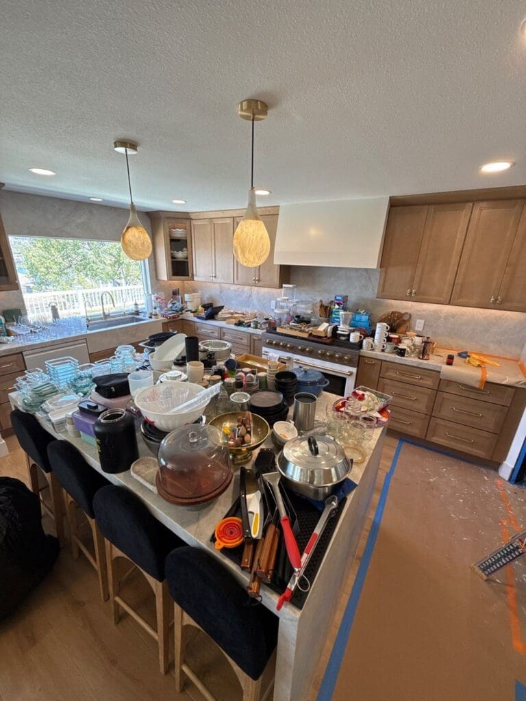 Kitchen island covered in items mid-unpack in a remodeled Mission Viejo kitchen