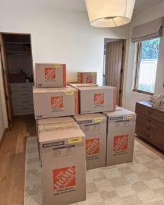 Moving boxes stacked in a bedroom waiting to be unpacked, San Diego