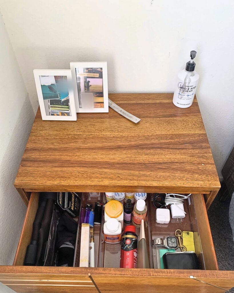 Same nightstand after Simply Luxe organizing, with a clear top, framed photos and a neatly sorted drawer, Costa Mesa