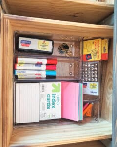 Office drawer after organizing with supplies sorted into clear dividers, Los Angeles