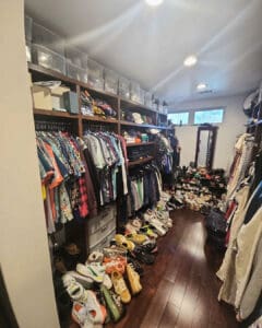 Crowded walk-in closet before decluttering, with full shelves and shoes lining the floor, San Diego