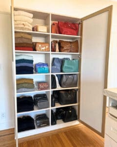 Organized closet shelves with folded sweaters and handbags lined up by color, San Diego