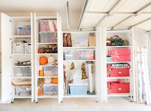 Organized storage shelves with holiday decorations.