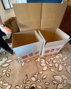 Moving boxes being assembled on packing day in a high rise condo, Orange County