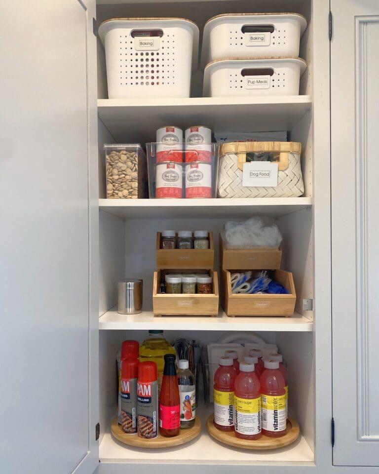 Pantry cabinet organized with labeled white bins, bamboo spice risers and wood lazy Susans for oils and drinks, organized by Simply Luxe, Lake Arrowhead
