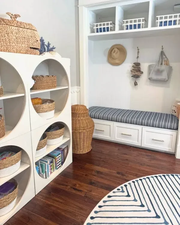 Playroom after organizing, with woven baskets in round cubbies and a styled window seat, Los Angeles