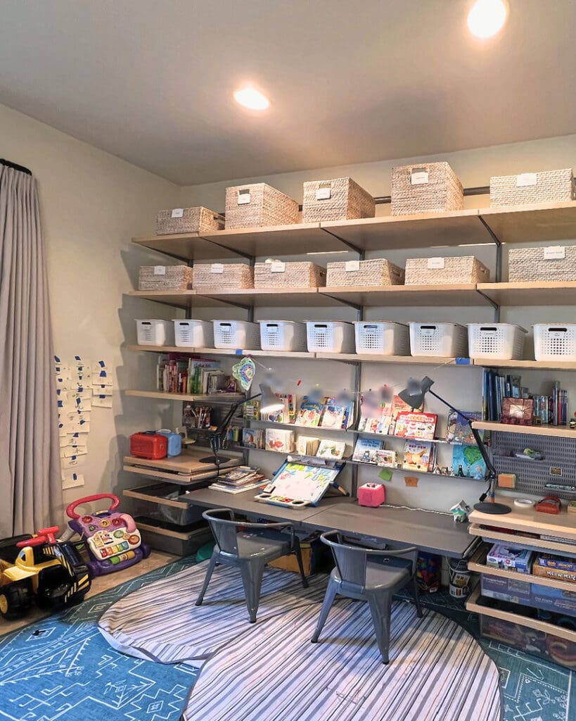 Organized playroom in Solana Beach with labeled baskets, shelves and desk by our team