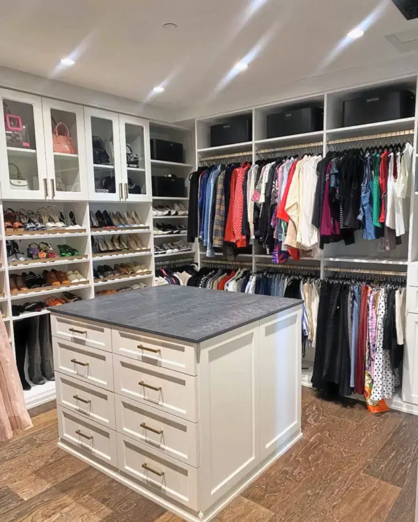 Same primary closet after the Simply Luxe unpack, with clothes hung by color, shoes on glass shelves and bins up top, San Diego