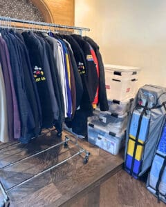Rolling racks of hanging clothes and wardrobe bags waiting to be unpacked in the new home, San Diego