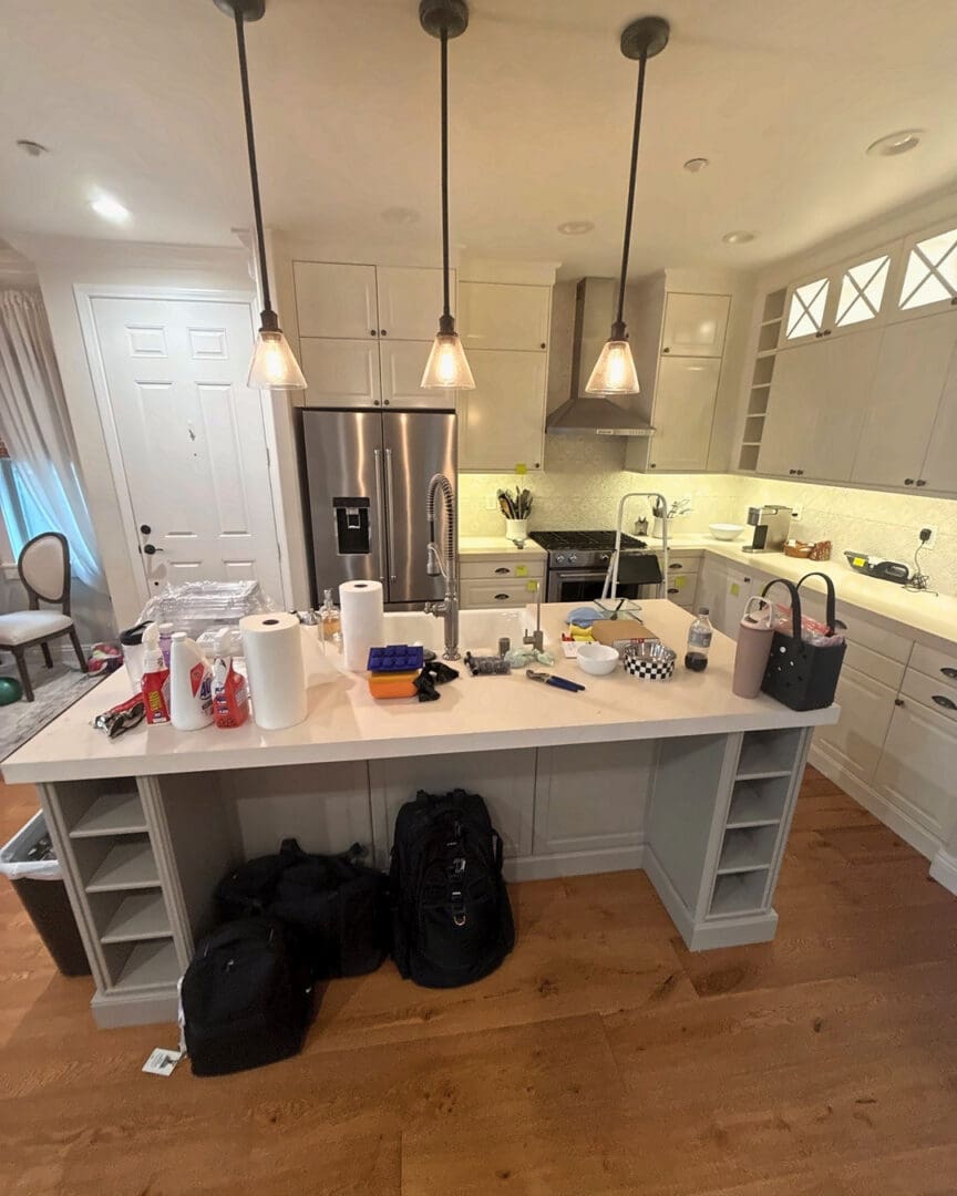 San Diego move-in kitchen before unpacking, island covered with bags and boxes