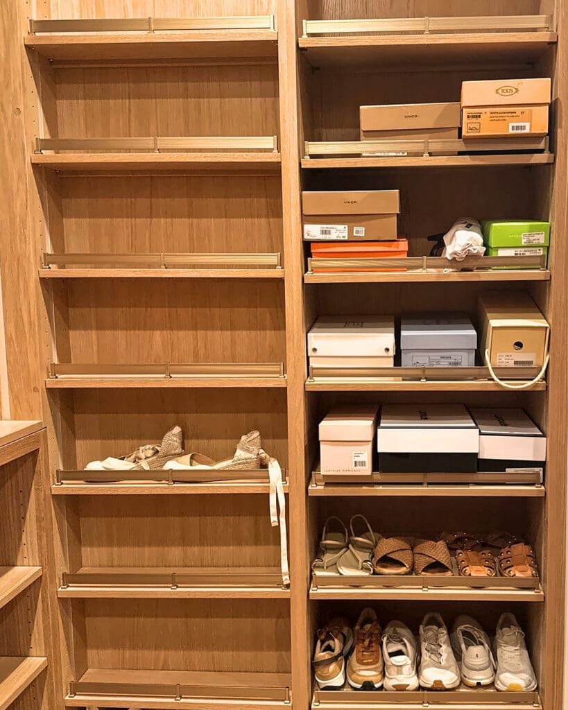 Shoe wall before organizing, with shoe boxes and a few pairs scattered across the shelves, San Diego